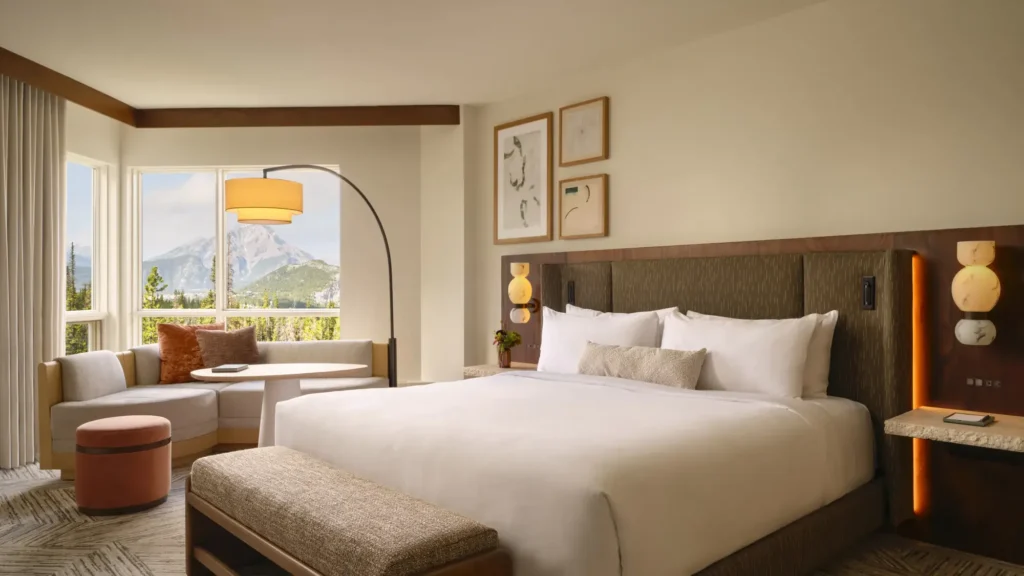 Rimrock Banff guestroom with a king bed, window seat and mountain view