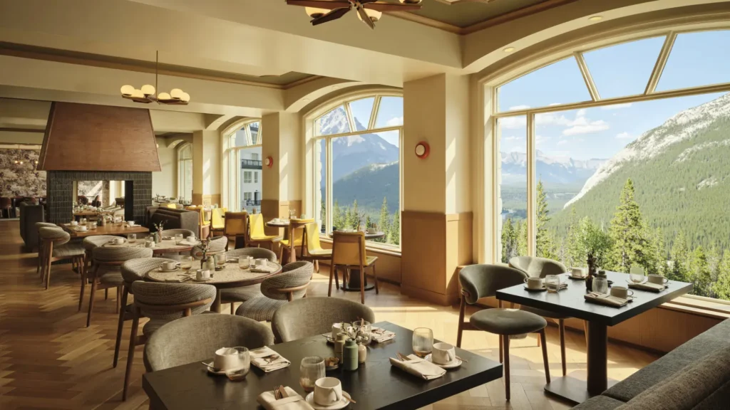 Parker's Table restaurant at Rimrock Banff with arched windows over the forested valley