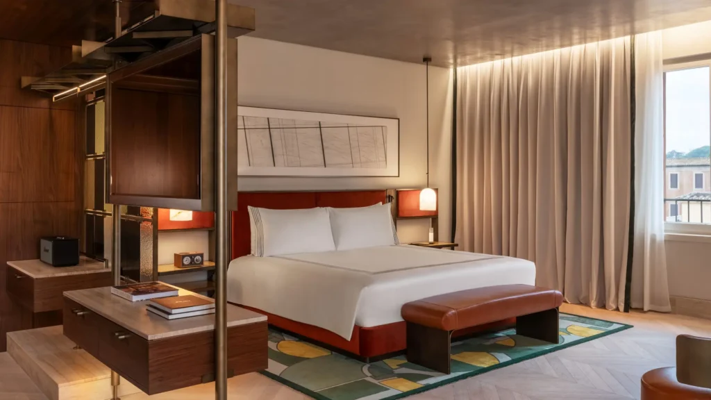 Guest room with a red bed, walnut cabinetry and a patterned rug