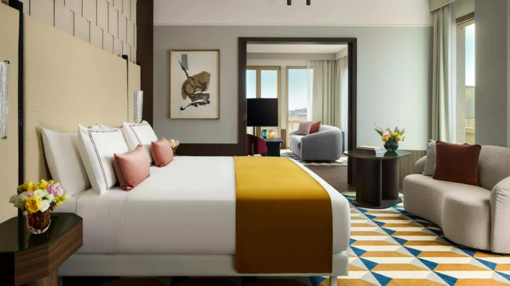 Bedroom in the Presidential Suite at Tivoli President Milano with a mustard throw and geometric rug